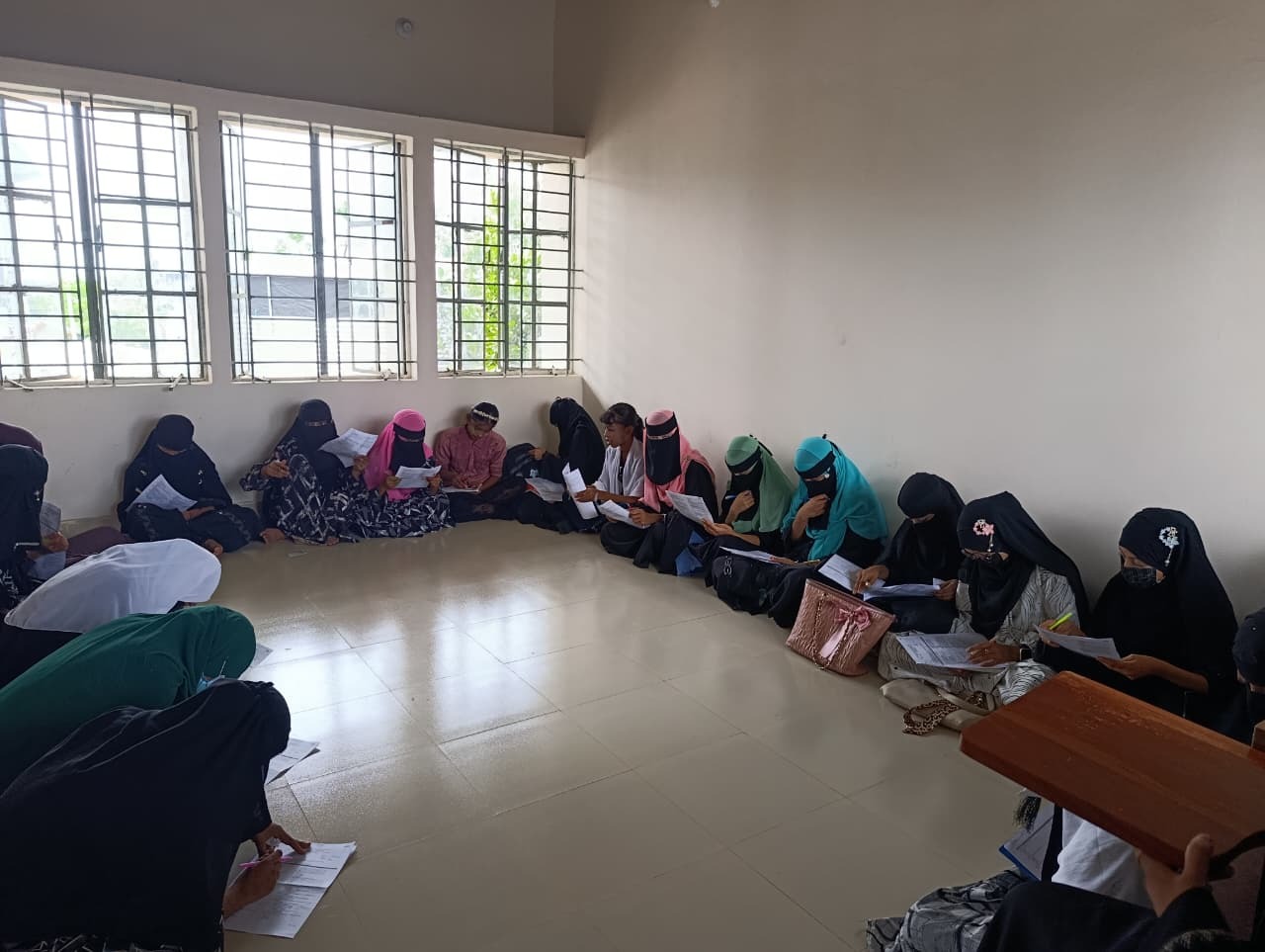 Group of female students in a classroom session reviewing course materials